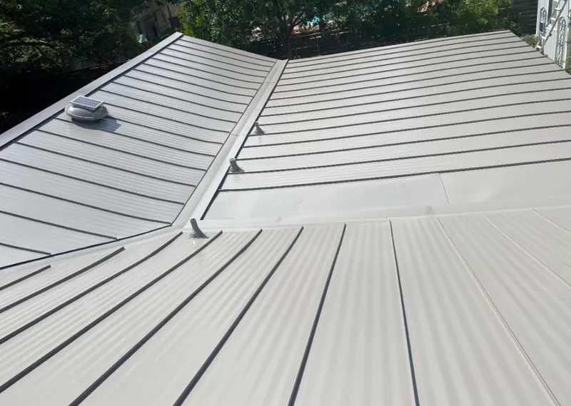 Solar attic fan installed on a metal roof for Roof Ventilation in Oil City